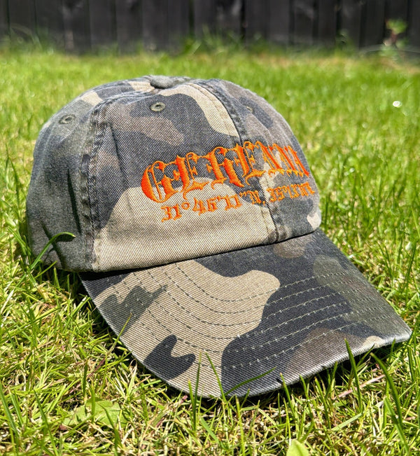 Camouflage baseball cap with orange text
